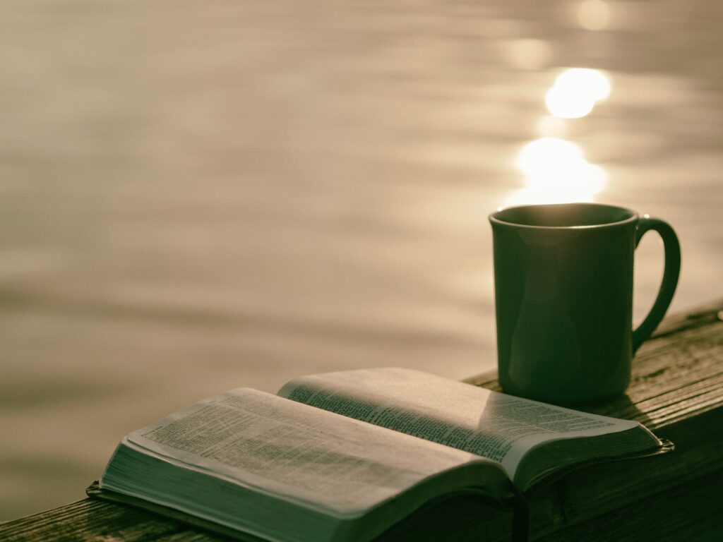 Bible & Coffe cup by water