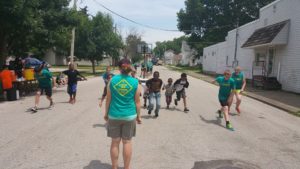 Faith Church 4:TWELVE Student Ministries teens playing Red Light, Green Light with neighborhood children in downtown Lafayette.