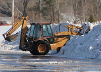 Snow being cleared from parking lot