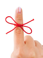 Red string tied on a finger