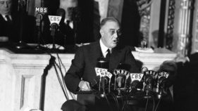 FILE - In this Jan. 6, 1941 file photo President Franklin D. Roosevelt adresses a joint session of Congress as  Speaker Sam Rayburn, left, and Vice President John N. Garner, look on.  With World War II looming, Roosevelt used his 1941 address to outline the 