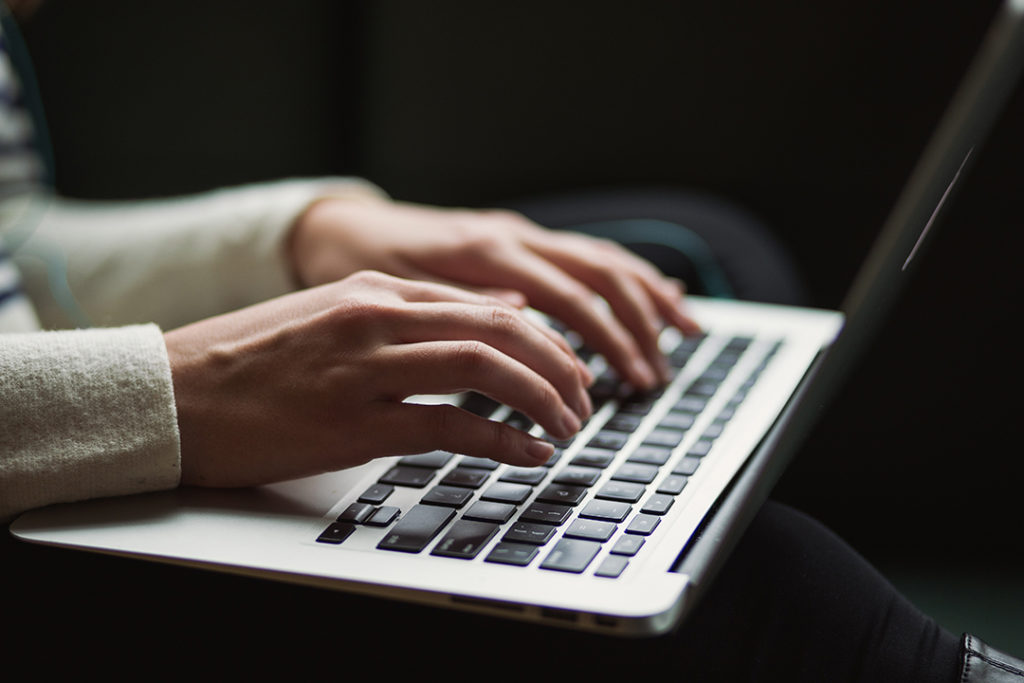 woman typing on a laptop